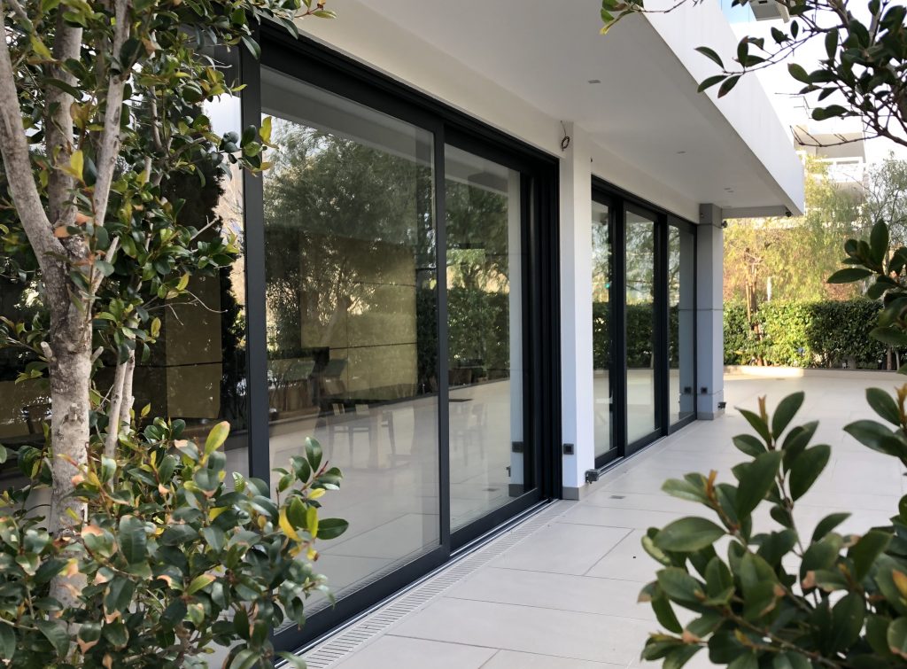 two sets of aluminium sliding doors on a patio.